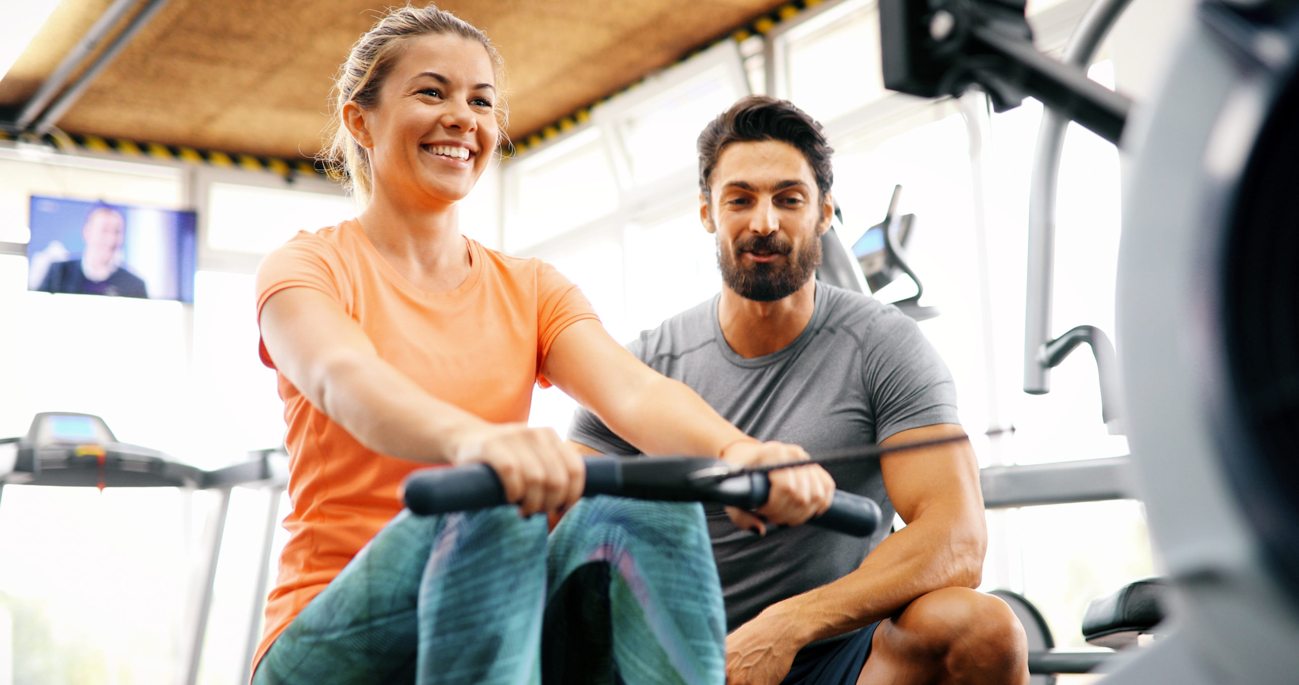 Personal trainer helping young woman reach goals